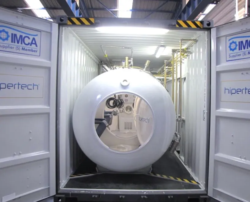 Looking into a container at the chamber inside, both doors carrying Hipertech and IMCA Supplier (S) Member decals